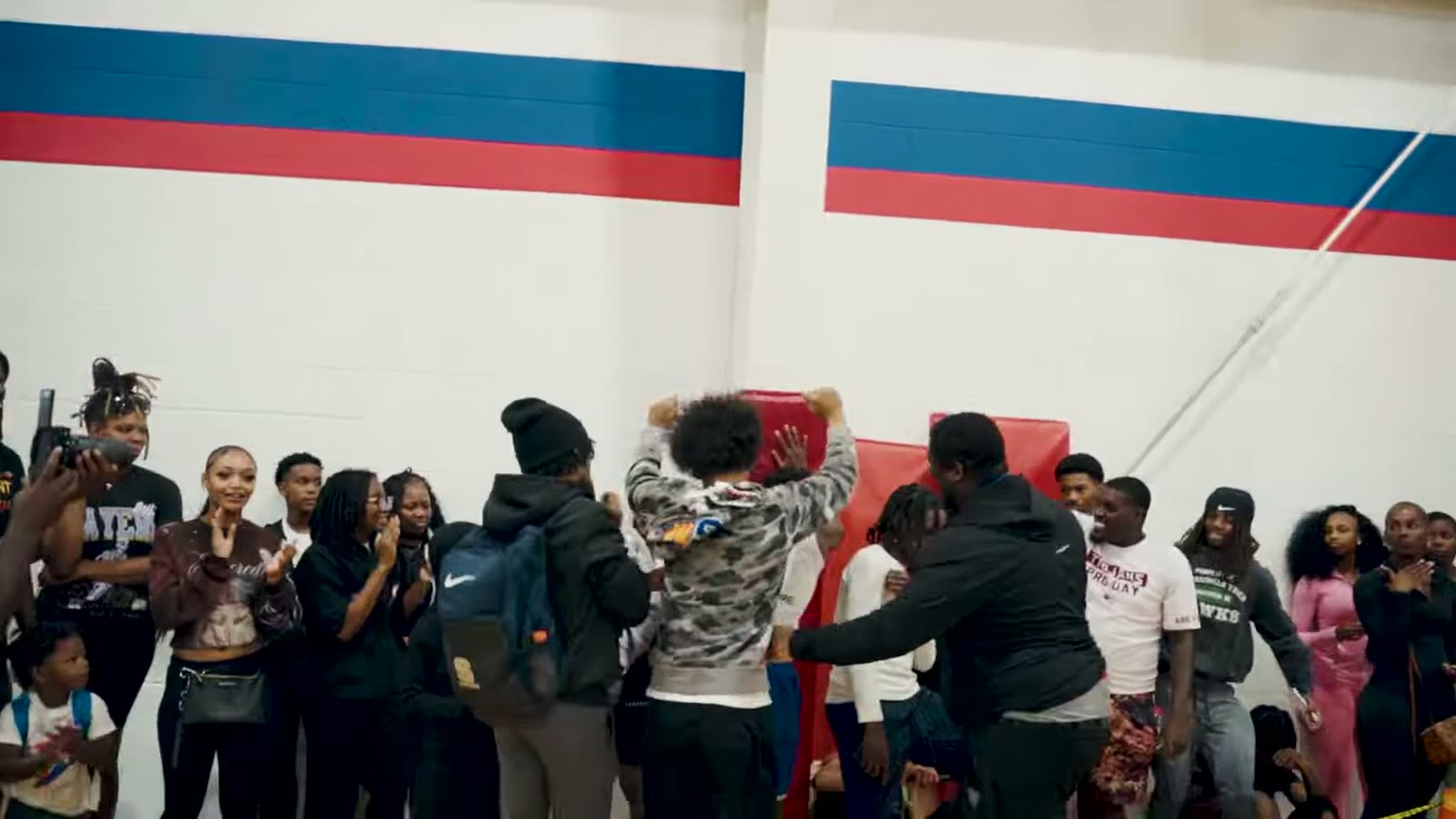 Crowd mobbing the floor after the final bucket