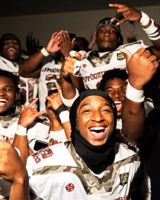 Football team celebrating in the locker room after a win