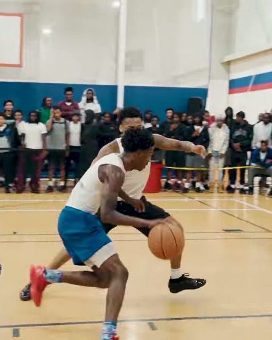 A low crossover in front of a packed gym at the Dreamers Classic
